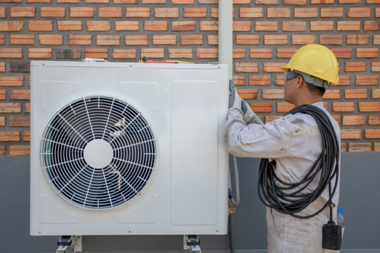 air,conditioning,technician,and,a,part,of,preparing,to,install